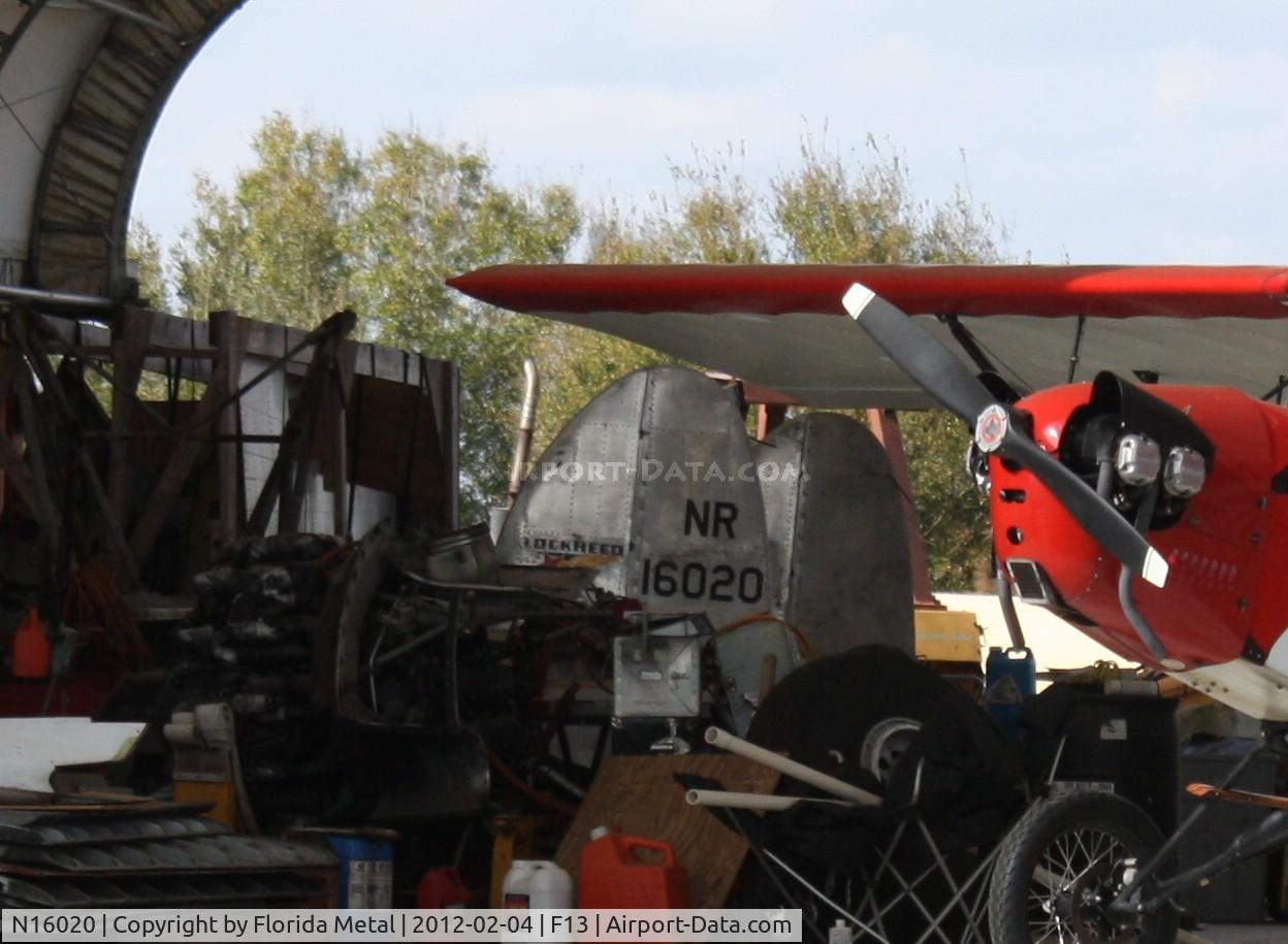 N16020, Lockheed Electra 10-E C/N 1055, Not a good shot I know, but I thought the content was worth it - a tail section of a Lockheed Electra 10-E burried in a barn behind a bunch of other aircraft parts, a Pietenpole Air Camper in mint condition and a cockpit section of a C-47 (not shown)