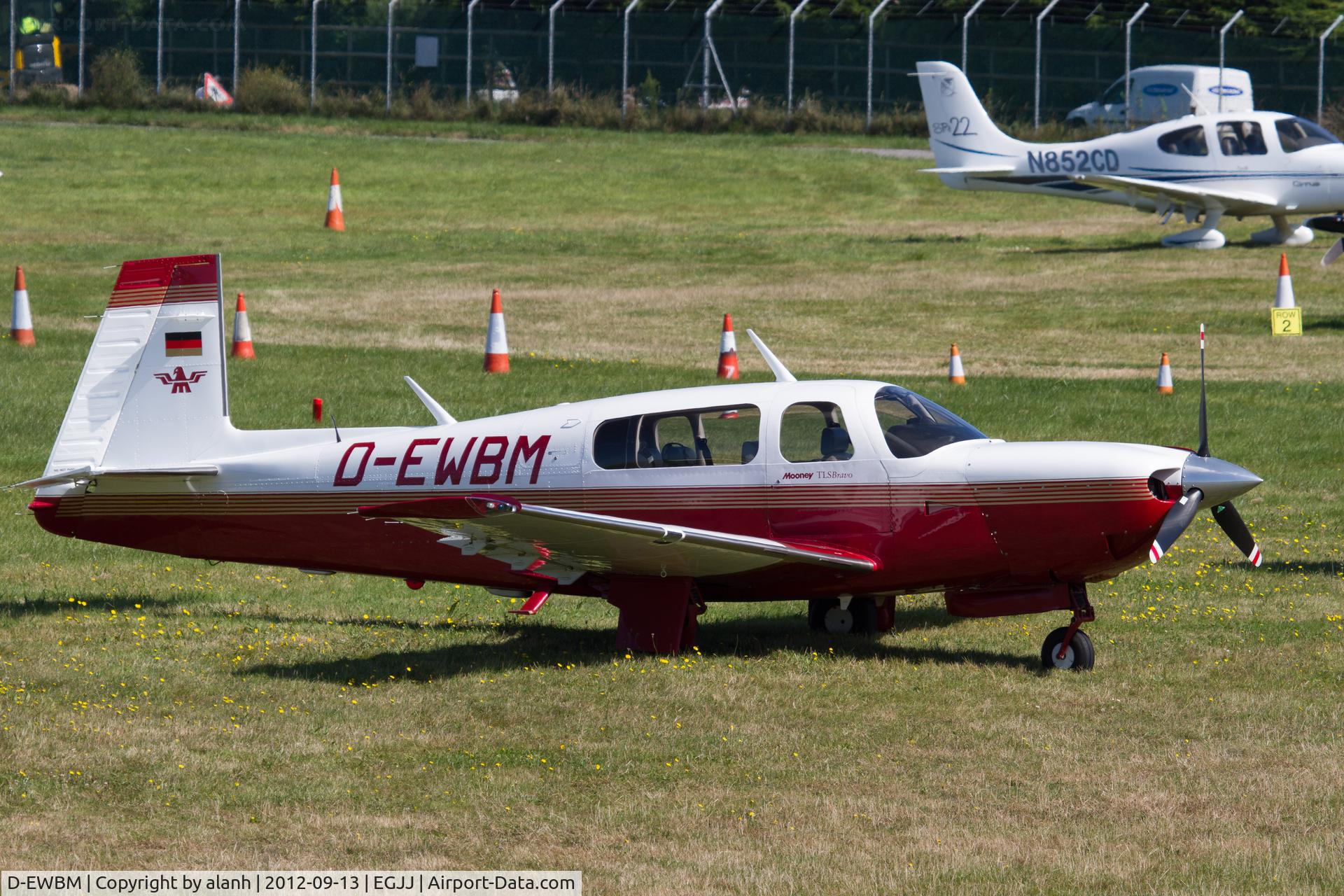 D-EWBM, Mooney M20M TLS Bravo C/N 27-0225, Parked on the grass near Jersey Aero Club