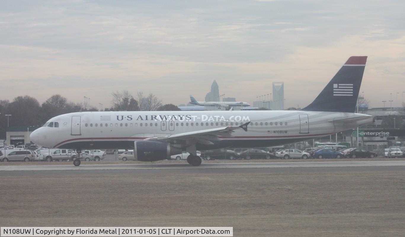 N108UW, 1999 Airbus A320-214 C/N 1061, US Airways A320 taken from inside my USAirways A319 (N744P - Piedmont colors).  ATI DC-8 looks like it is going to land on top of the A320