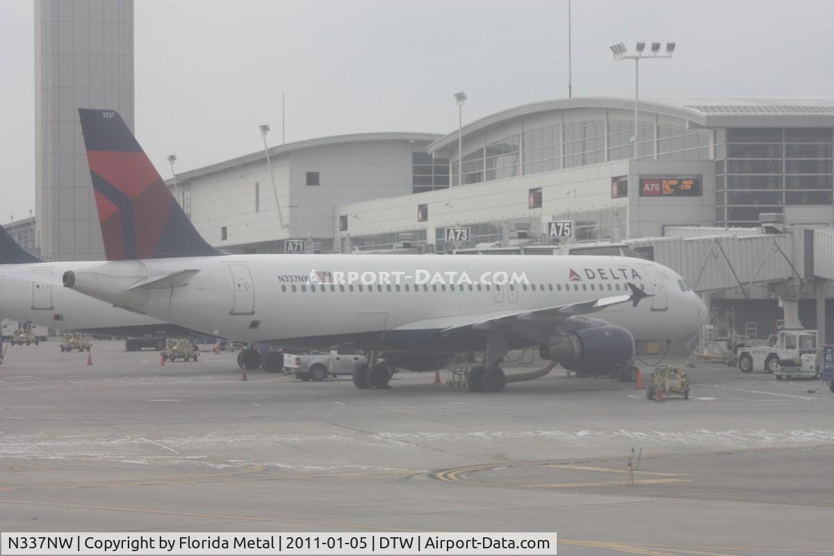 N337NW, 1992 Airbus A320-212 C/N 358, Delta A320 at McNamara Terminal - taken out of the hazed window of a US Airways A319