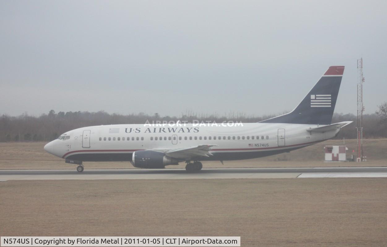 N574US, 1987 Boeing 737-301 C/N 23739, US Airways 737-300 departing at CLT - taken out of the hazy window of my US Airways A319