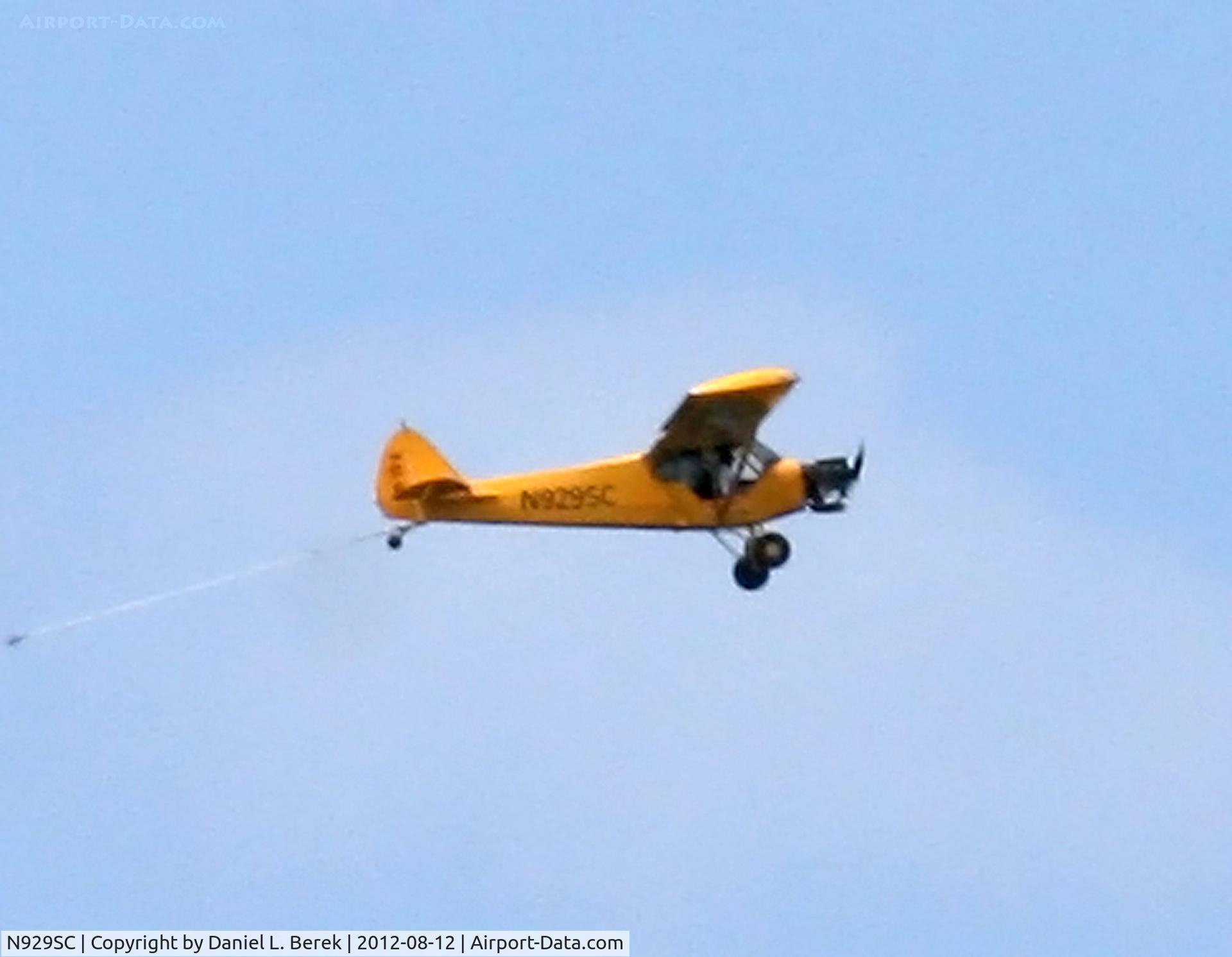 N929SC, 1978 Piper PA-18-150 Super Cub C/N 18-7909002, A hard-working Piper Super Cub tows banners over the northern coast of old San Juan, PR.