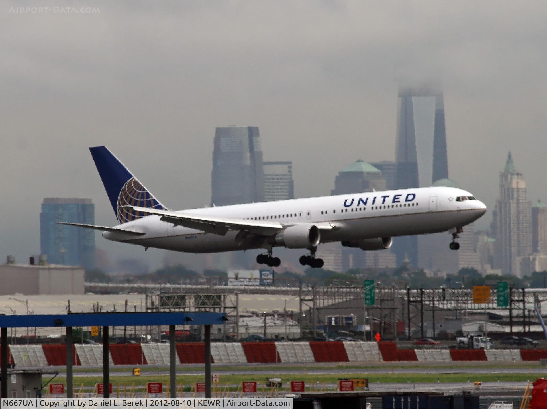 N667UA, 1998 Boeing 767-322 C/N 29239, The stormy sky and Manhattan skyline provide a dramatic backdrop as this UA Boeing 767 battles bad weather and strong winds to land on Newark's shortest runway.