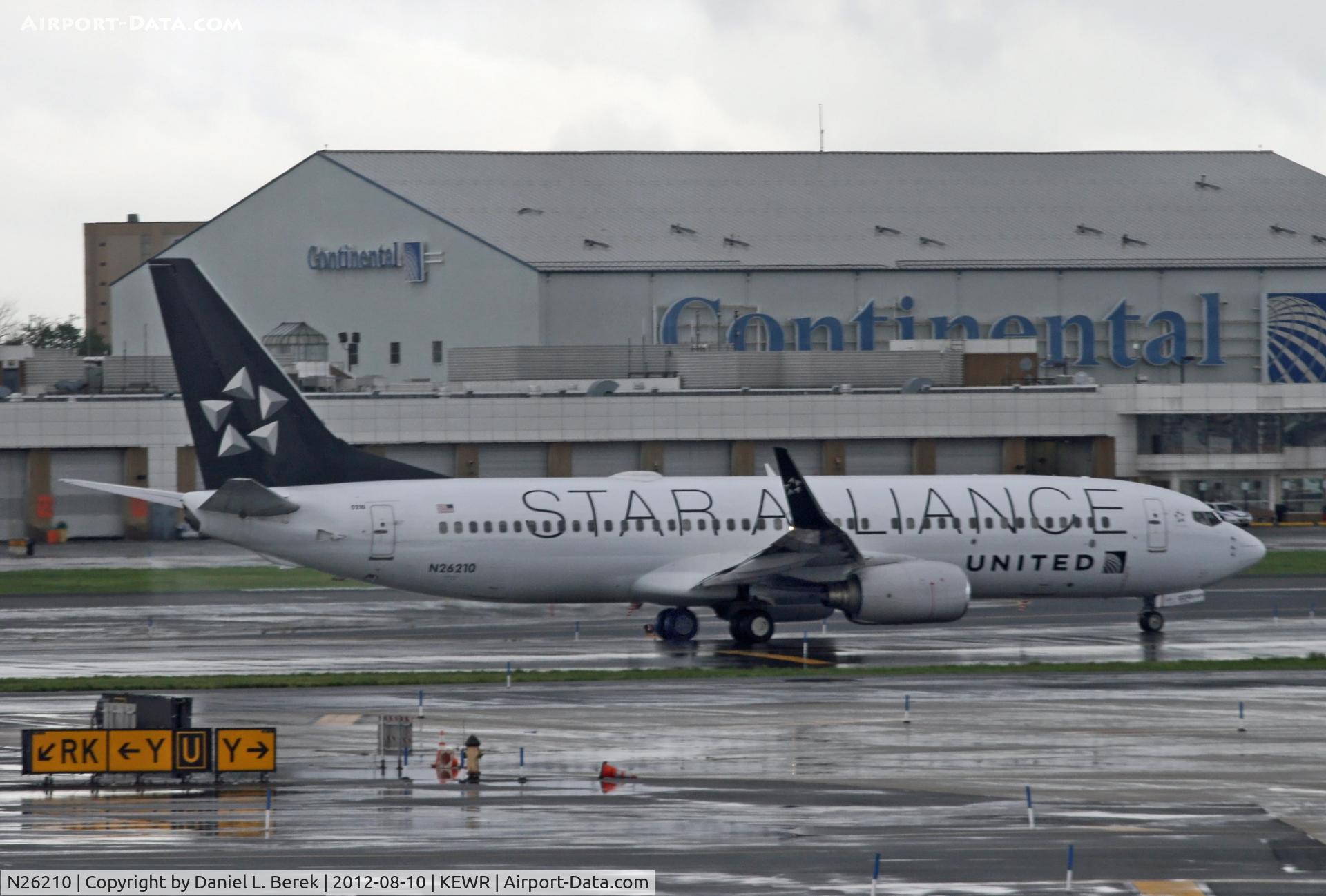N26210, 1998 Boeing 737-824 C/N 28770, I caught the UA Star Alliance Boeing 737 on a very wet day in Newark.  Note the old Continental name on the freight building in the background.