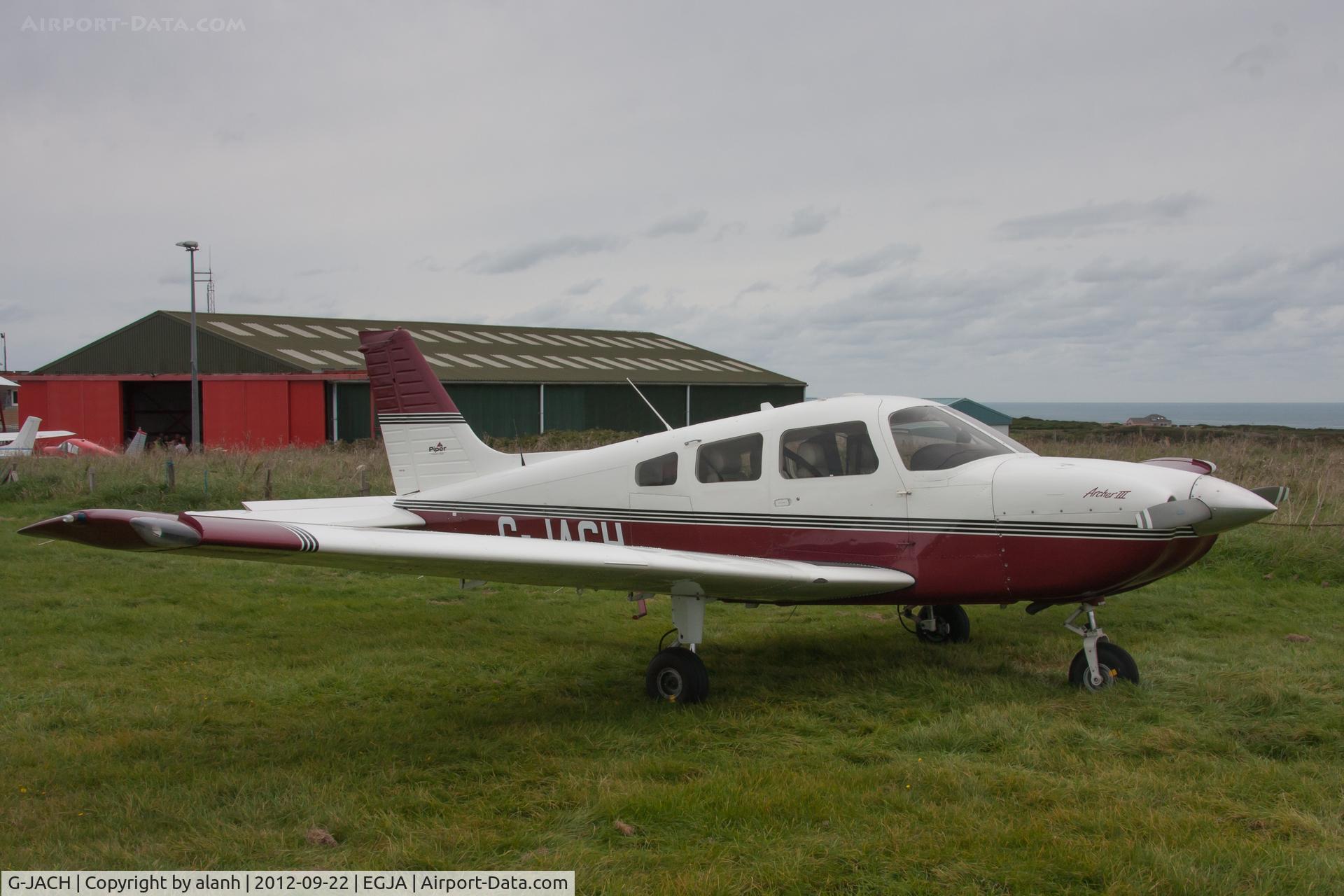 G-JACH, 2003 Piper PA-28-181 Cherokee Archer III C/N 2843585, parked on the grass at the edge of the airfield