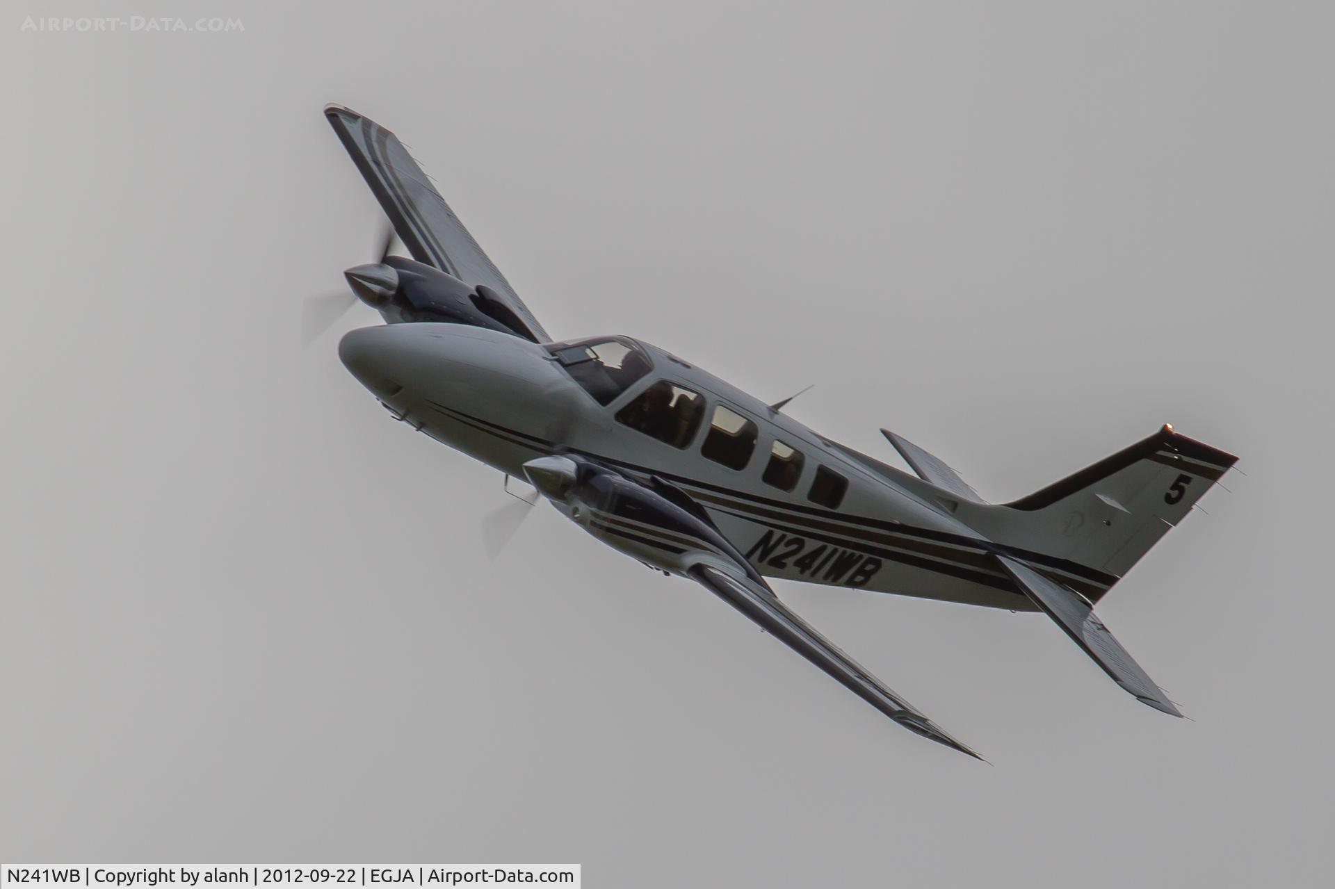 N241WB, Hawker Beechcraft Corp G58 Baron C/N TH-2246, Banking round a course marker and just about to pass in front of the hazy sun - not an ideal photographic position