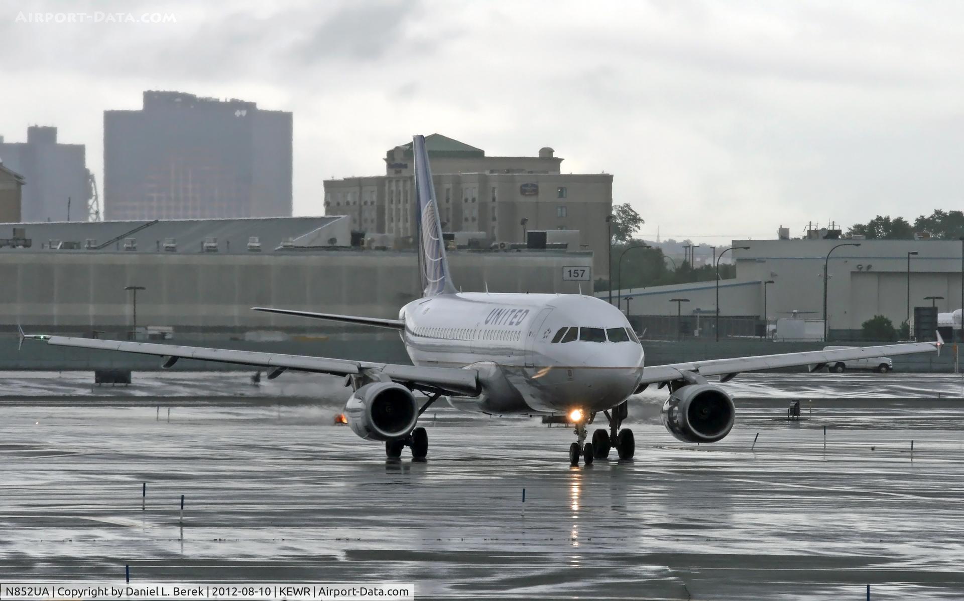 N852UA, 2002 Airbus A319-131 C/N 1671, A United Airbus A319 taxies in at a very wet Newark International, having weathered severe rainstorms.