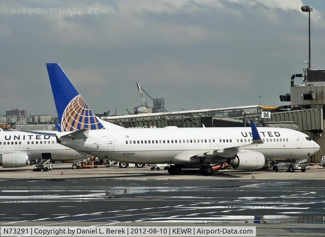 N73291, 2004 Boeing 737-824 C/N 33454, Puddles from a recent downpour reflect one of United's ex-Continental Boeing 737s.