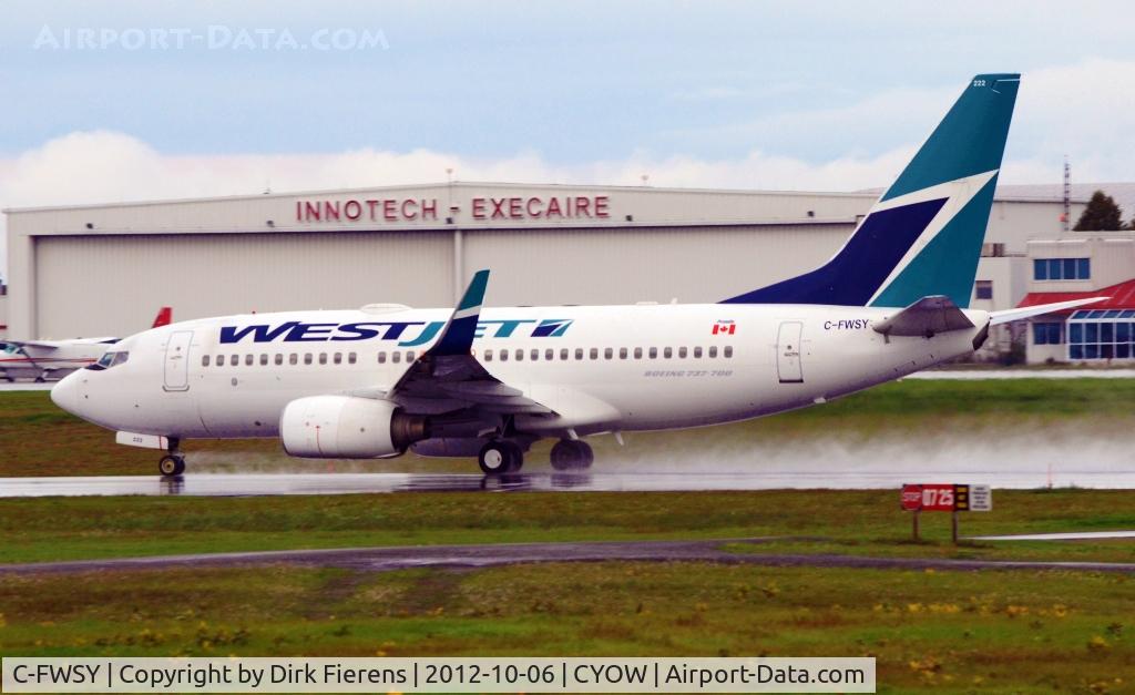 C-FWSY, 2004 Boeing 737-7CT C/N 32762, A wet morning takeoff run on rwy 25 at Ottawa's Airport.