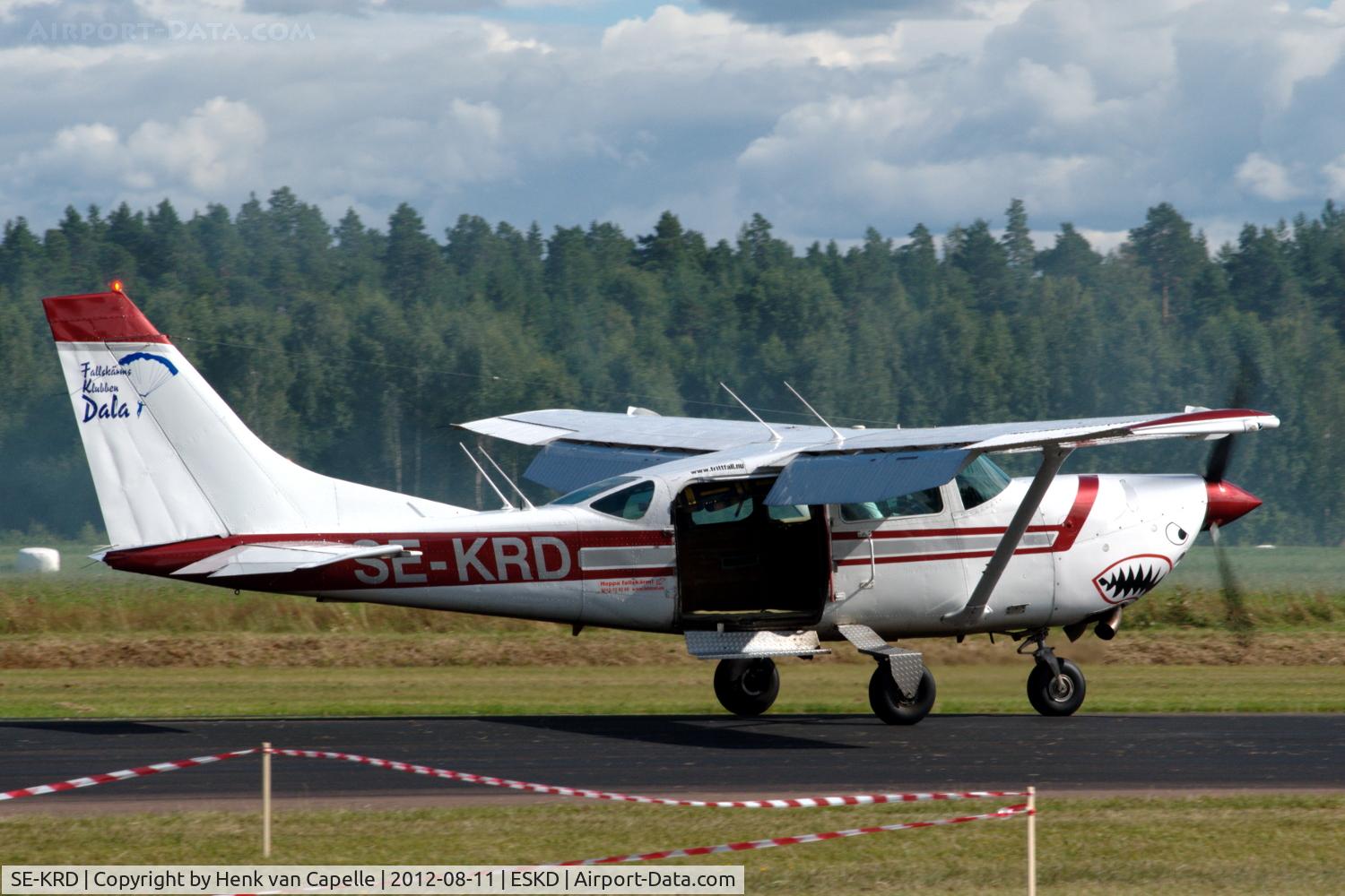 SE-KRD, 1980 Cessna U206G Stationair C/N U206-05771, A Cessna U206G (Soloy conversion with tubine engine) landing at  Dala-Järna airfield, Sweden, after dropping parachutists. Even though looking somewhat worn it has a rather nice shark-mouth on its engine cowling.