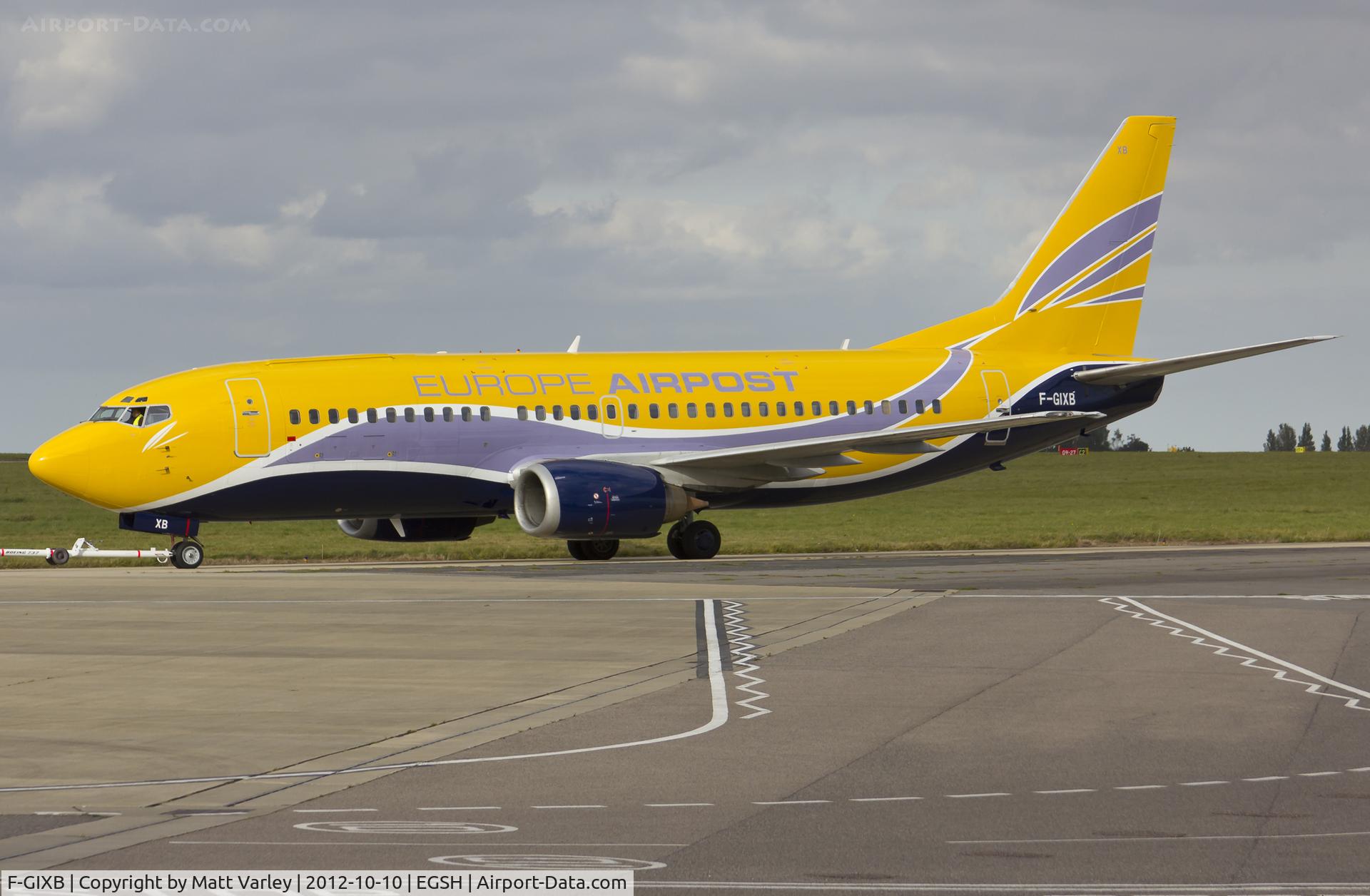 F-GIXB, 1990 Boeing 737-33A(QC) C/N 24789, Being towed to stand 8 after spray by Air livery.