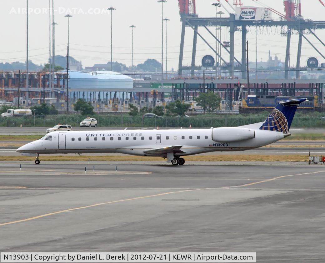 N13903, 2001 Embraer ERJ-145LR (EMB-145LR) C/N 145479, This regional jet appears to be dwarfed by all the industrial equipment of Port Elizabeth in the background.