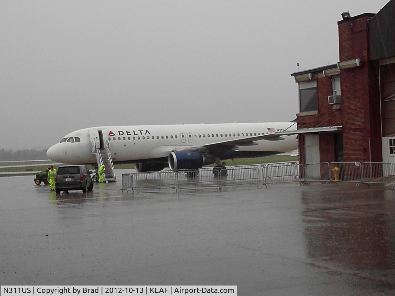 N311US, 1990 Airbus A320-211 C/N 125, after http://flightaware.com/live/flight/DAL8931/history/20121013/1737Z/KMSP/KLAF waiting to take University of Wisconsin football team back to Madison.