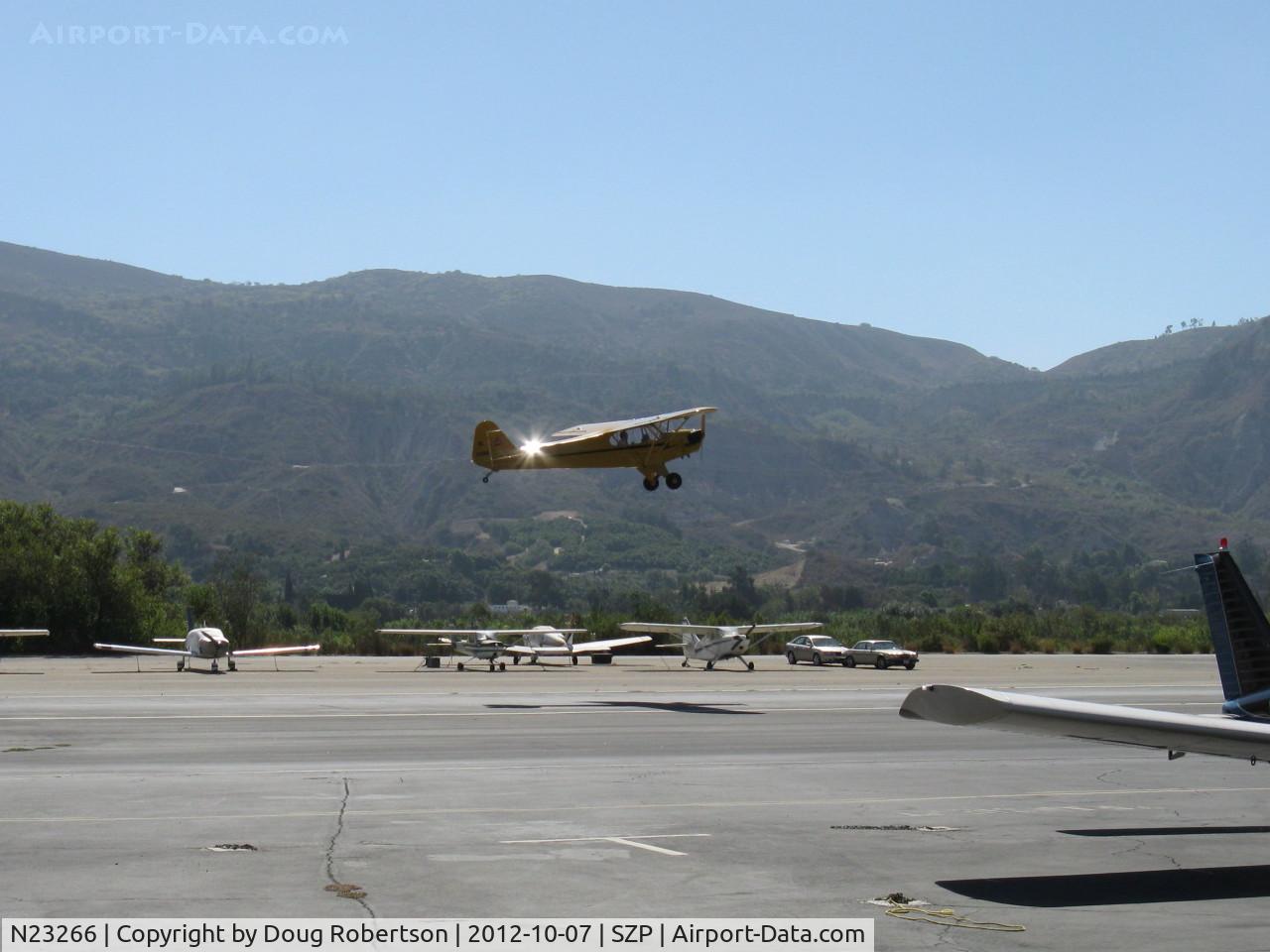 N23266, 1939 Piper J3C-65 Cub Cub C/N 3113, 1939 Piper J3C-65 CUB, Continental A&C65 65 Hp, takeoff climb Rwy 22, Young Eagles Flight in an airplane certainly older than the child.