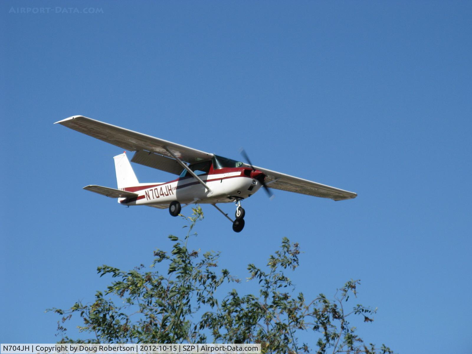 N704JH, 1976 Cessna 150M C/N 15078644, 1976 Cessna 150M, Continental O-200 100 Hp, on final Rwy 04 over the airport's western boundary. Full flap landing.