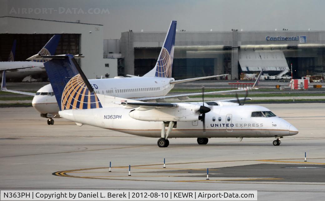 N363PH, 1998 Bombardier DHC-8-202 Dash 8 C/N 520, A United Express Dash-8 sashays past a United Boeing 737-924 at Newark International.