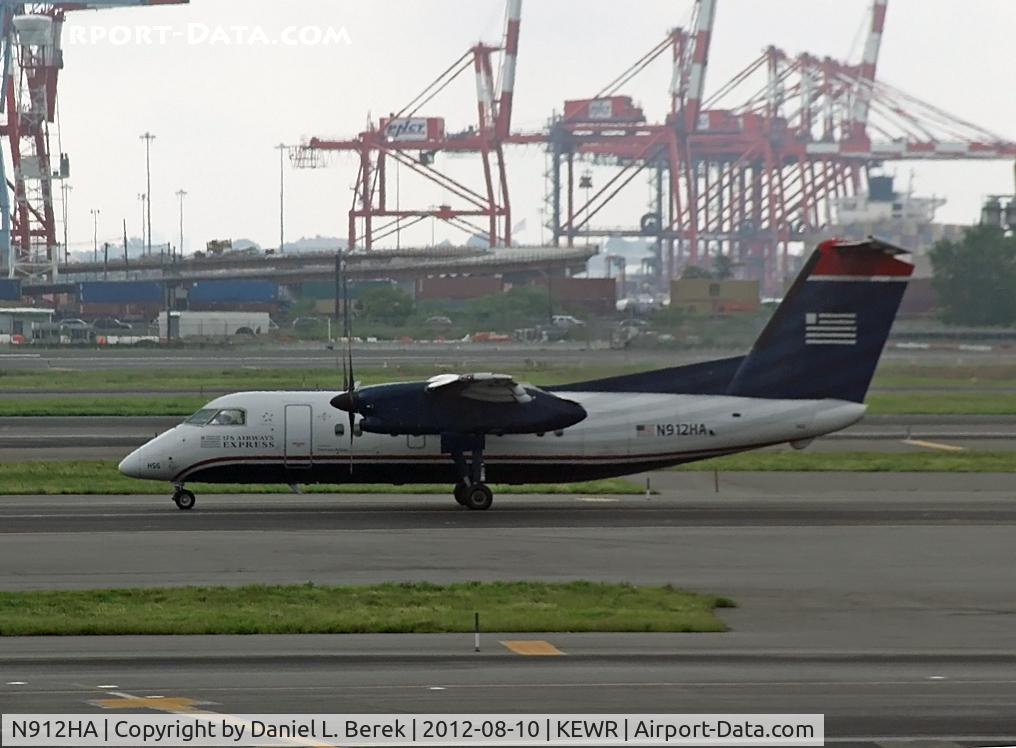 N912HA, De Havilland Canada DHC-8-102 Dash 8 C/N 040, The huge cranes of Port Newark seem to make this commuter airplane look like a toy.