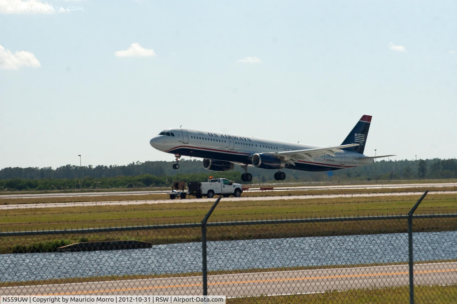 N559UW, 2012 Airbus A321-231 C/N 5292, Landing really close to ground crew working next to RWY 6