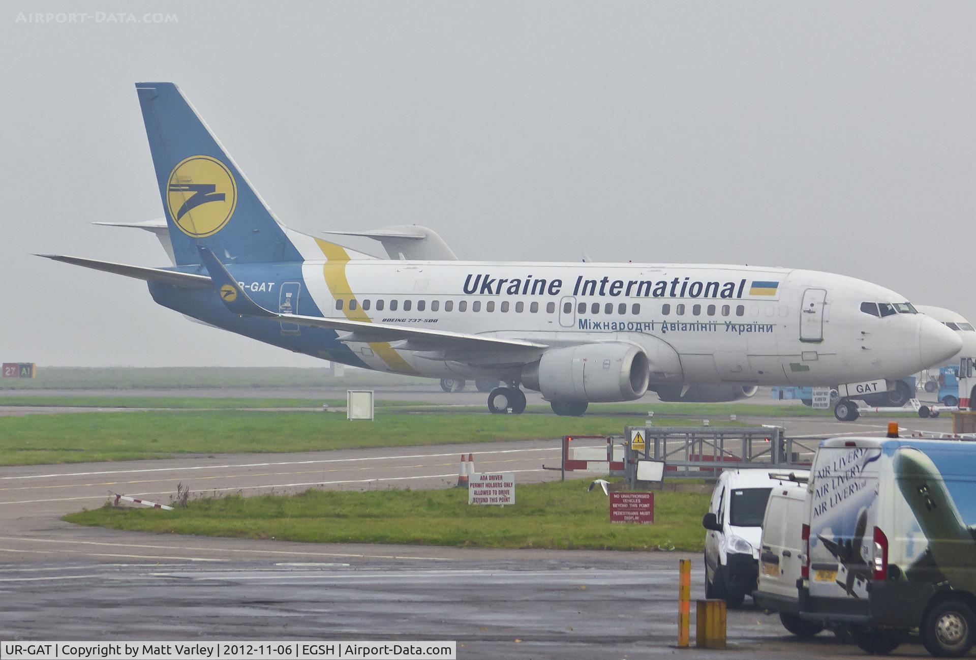 UR-GAT, 1993 Boeing 737-528 C/N 25237, Being towed in the fog to the Air Livery hangar.