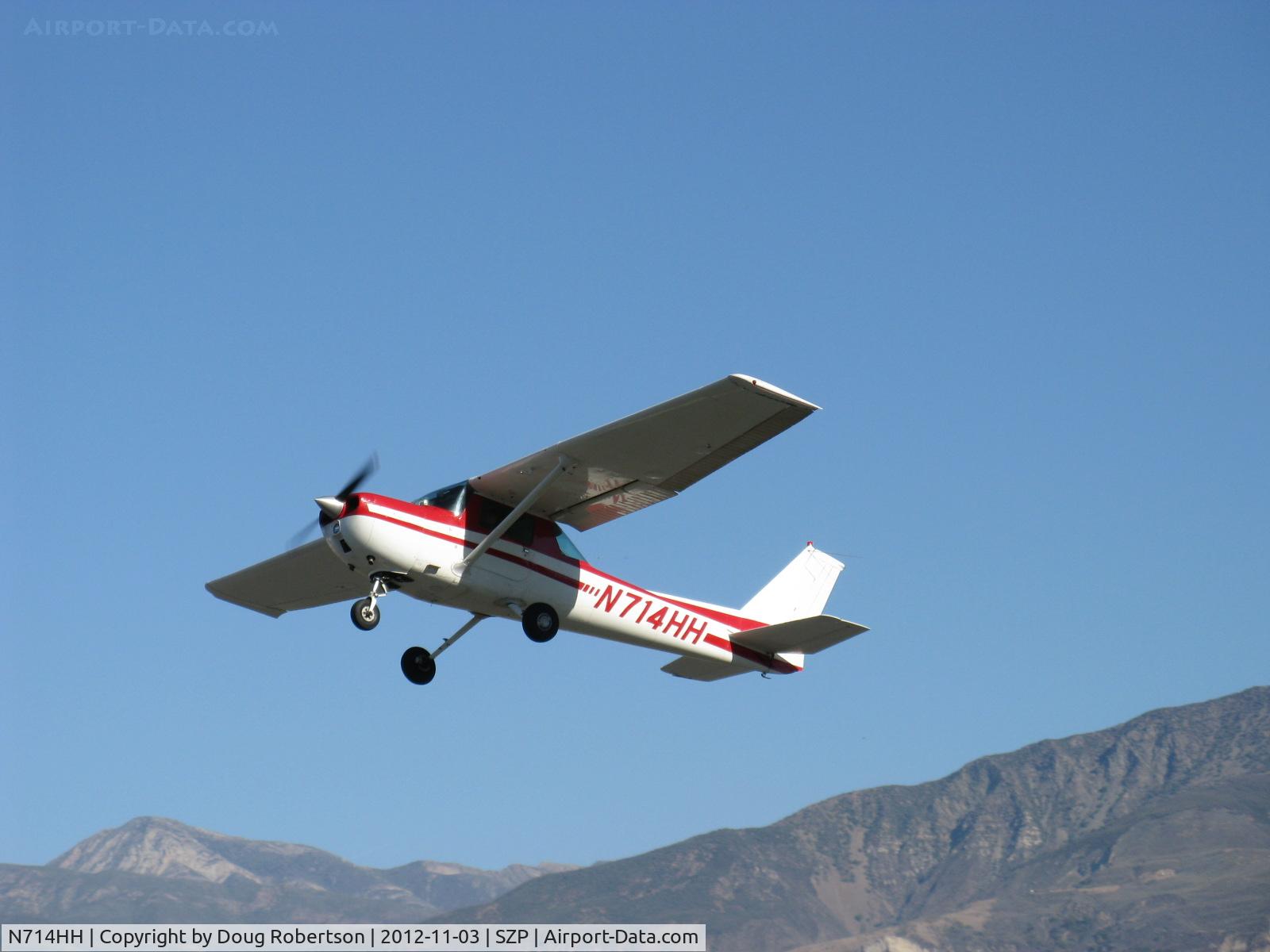 N714HH, 1977 Cessna 150M C/N 15079185, 1977 Cessna 150M, Continental O-200 100 Hp, takeoff climb Rwy 22. Hines Peak at 6,704' lower left.