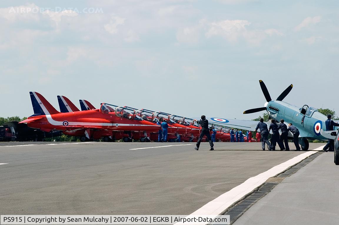 PS915, 1945 Supermarine 389 Spitfire PR.XIX C/N 6S/585121, BBMF Spitfire PS915 being pushed out prior to its display during the Biggin Hill International Air Fair, 2nd of June 2007. The RAF Red Arrows are seen in the background.