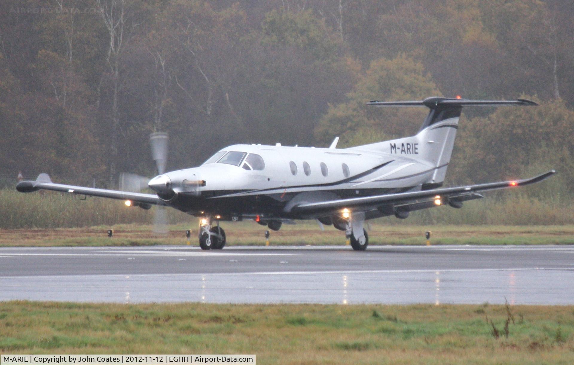 M-ARIE, 2010 Pilatus PC-12/47E C/N 1235, Departs through heavy drizzle.