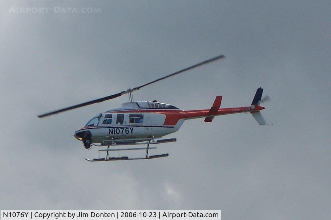 N1076Y, 1980 Bell 206L-1 LongRanger II C/N 45380, N1076Y flies over San Juan Harbor as the Navigator of the Seas pulls into port