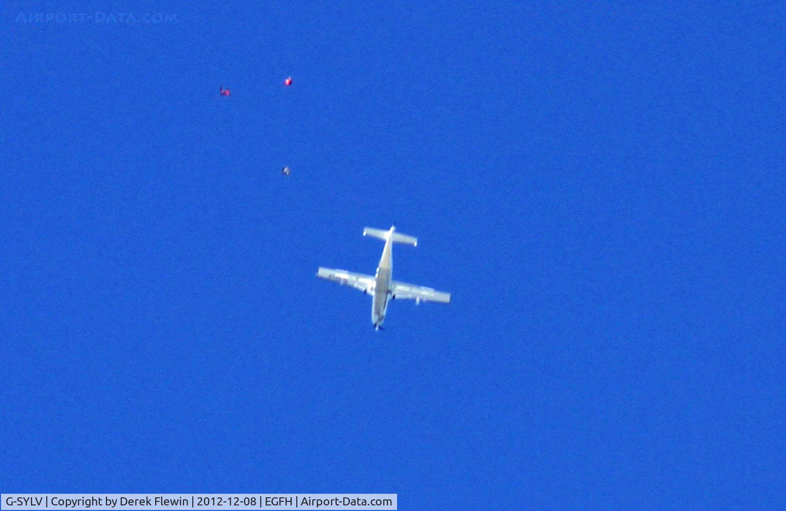 G-SYLV, 2002 Cessna 208B  Grand Caravan C/N 208B0936, 1st lift of the day, 12500', if you click on the photo you can see 3 parachutists exiting the ac.