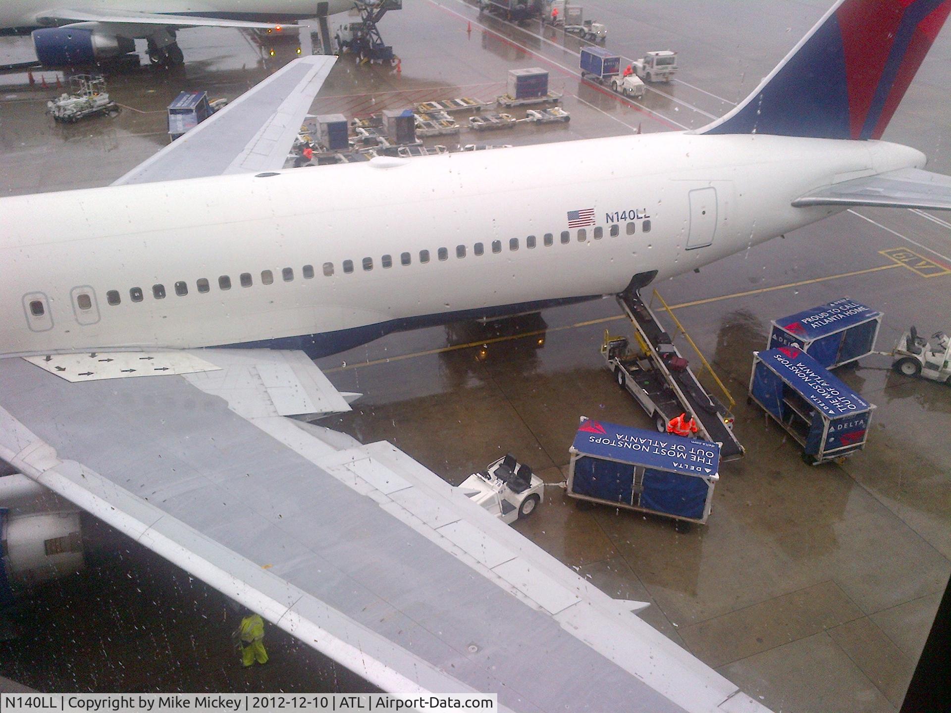 N140LL, 1993 Boeing 767-332 C/N 25988, At ATL on a rainy day