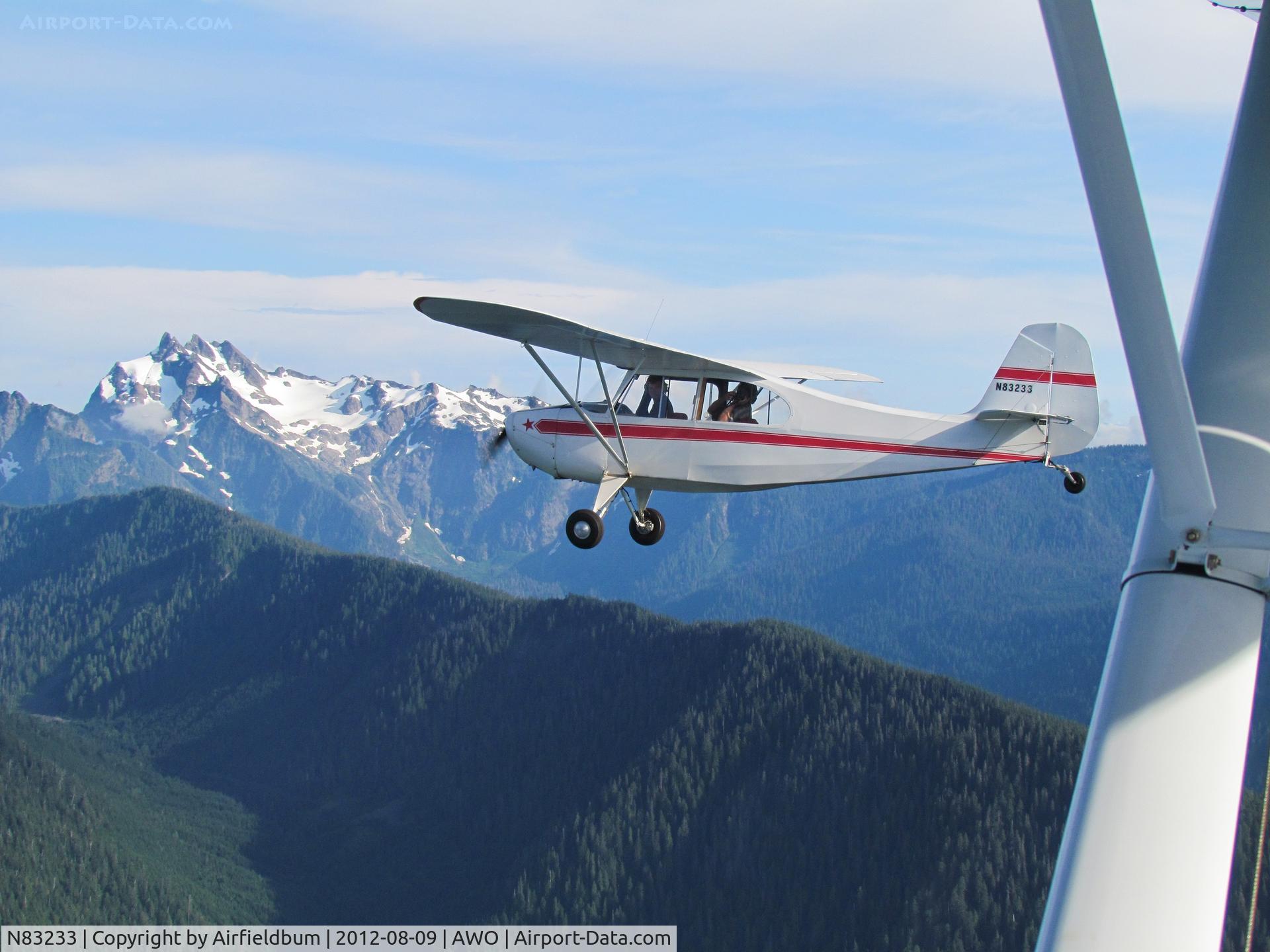 N83233, 1946 Champion 7AC C/N 7AC-1897, Eastbound 10 miles NE of KAWO with Mt Three Fingers in background.