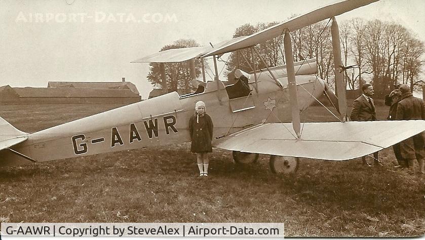 G-AAWR, De Havilland DH60G GIPSY MOTH C/N 1237, I believe this was taken at Castle Bromwich 1931/2. My mother Iris Flight age 10 is standing in front of DH Moth G-AAWR with white flying helmet on.  I have another photo of her sitting in the front cockpit.
