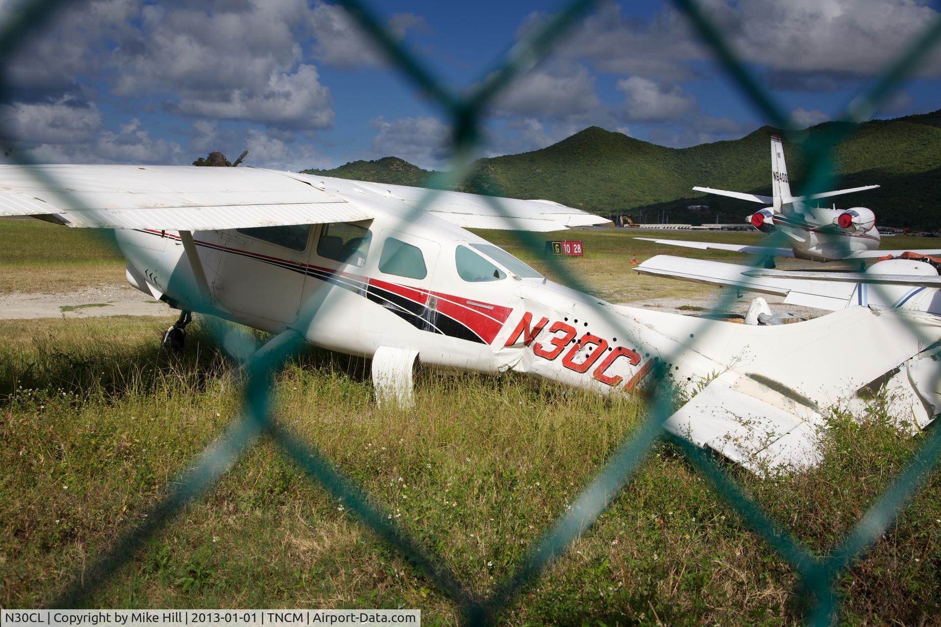 N30CL, 1965 Cessna 210E Centurion C/N 21058695, Rather sad aircraft remains off the GOLF ramp in Sint Maarten.  There's a story here, but I don't know what it is..