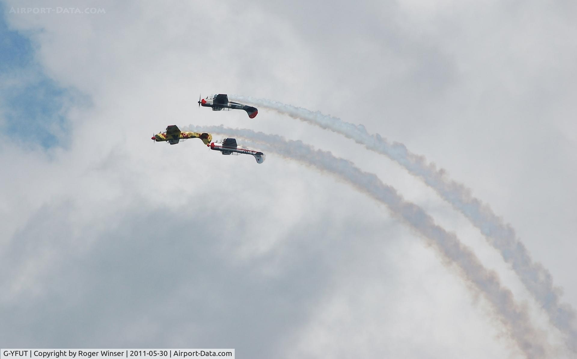 G-YFUT, 1988 Bacau Yak-52 C/N 888410, Off airport. Leading Team Osprey at the top of a loop at the 2011 Mumbles Navy Days display, Swansea Bay, Wales, UK