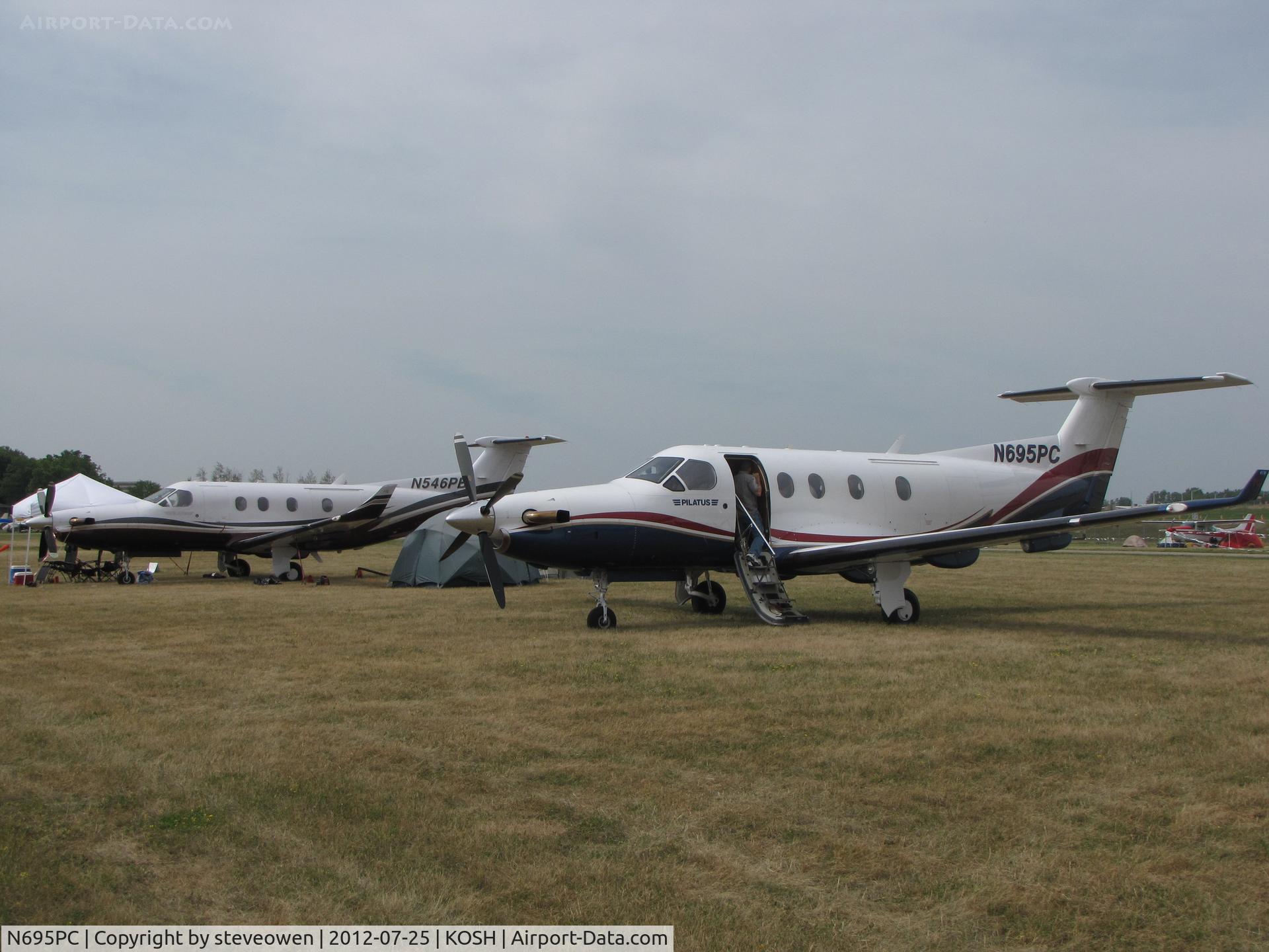 N695PC, 1999 Pilatus PC-12/45 C/N 305, In the camp grounds at EAA2012.N546PB in the back.
