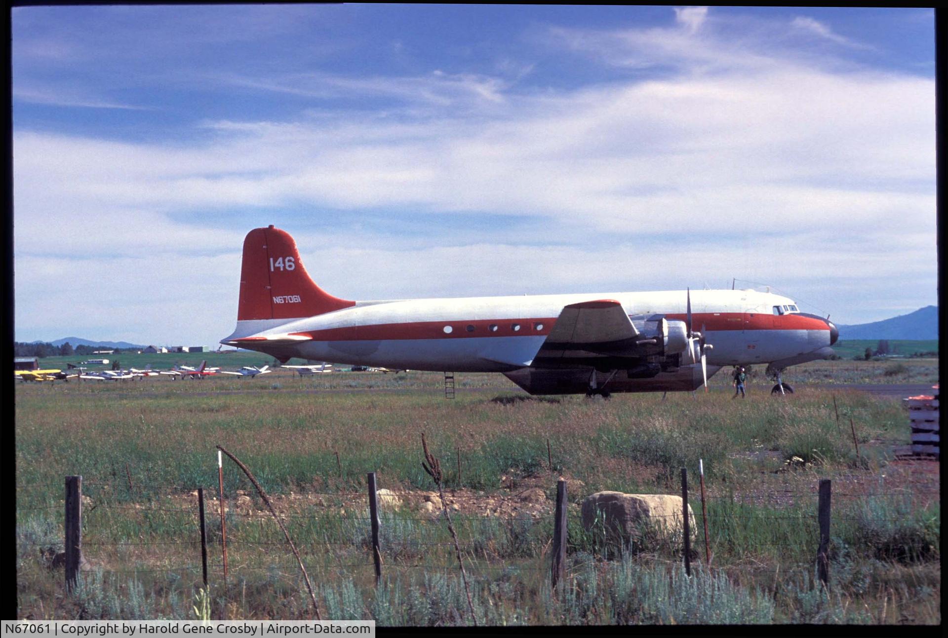 N67061, 1945 Douglas C-54Q C/N 10560, In Idaho, possibly McCall. Sometime in 1950 to 1960. Looks like a fire retardant pod on it. Probably taken by Harold Gene Crosby