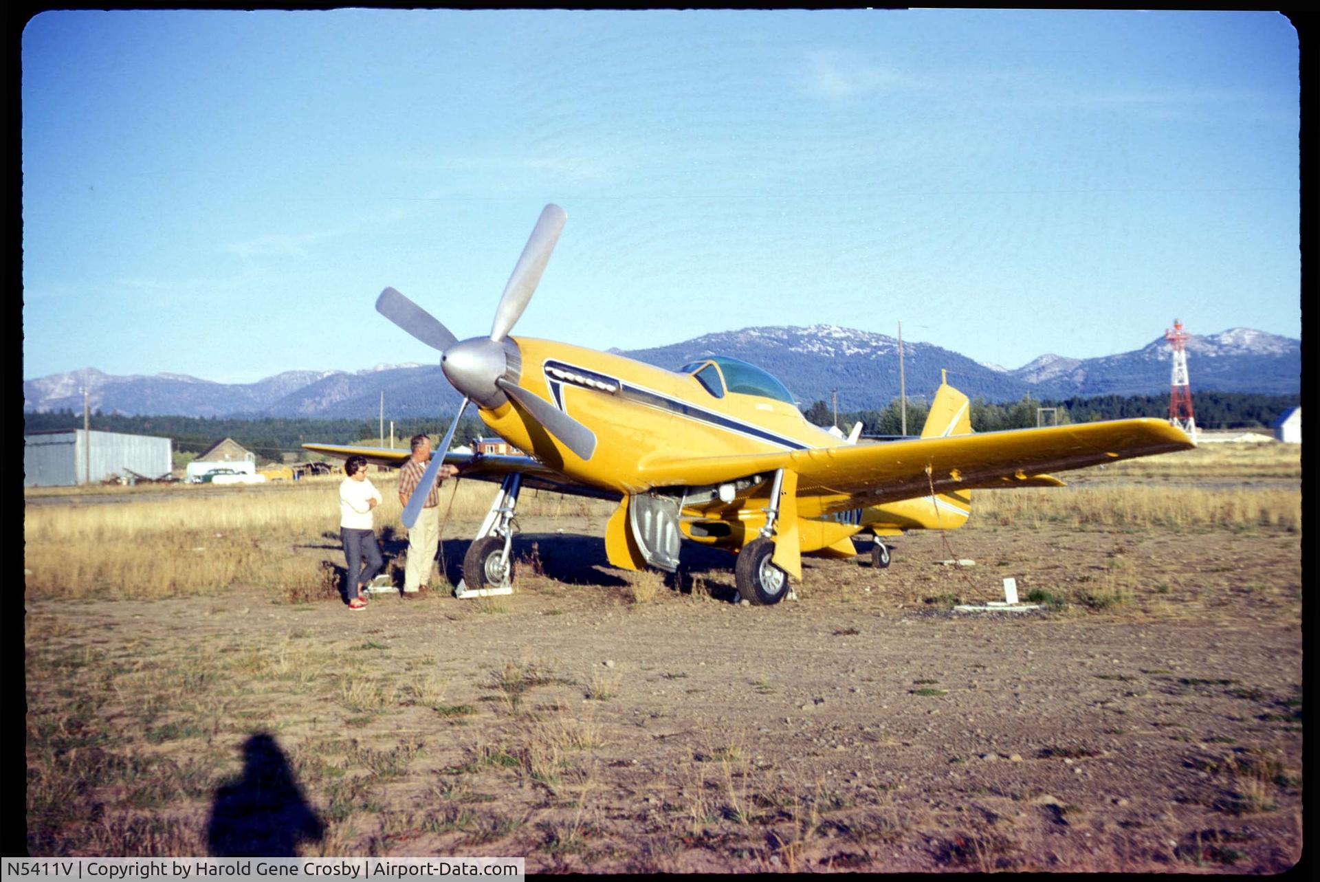 N5411V, 1944 North American P-51D Mustang C/N 122-31894 (44-72035), I am not sure of the tail number. But the last three partially visible digits certainly could be 411V This is the only Mustang I could find that looked like the N number matched up at all.

From an old slide, Probably in Idaho. Possibly McCall.