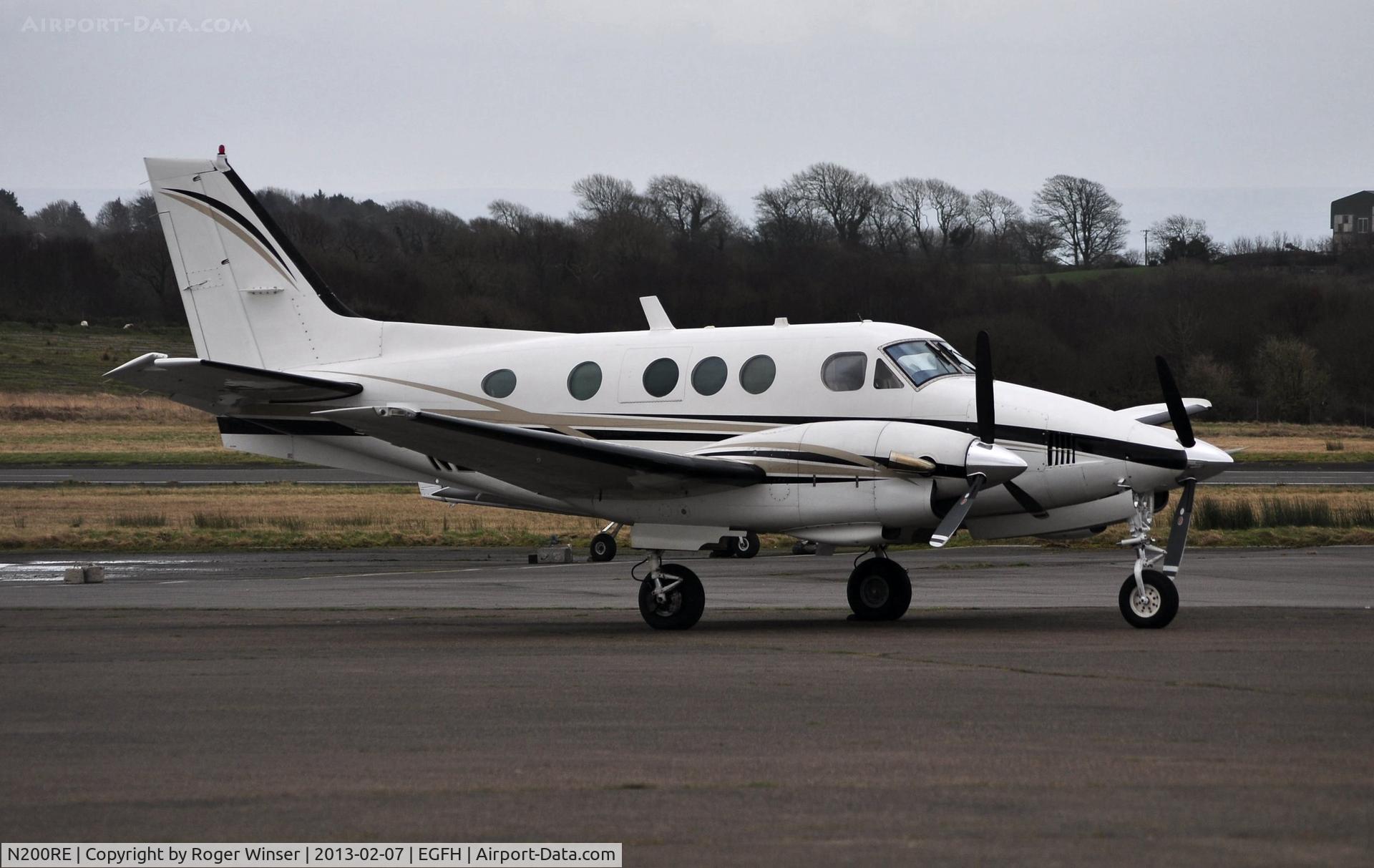 N200RE, 1975 Beech E90 King Air C/N LW-164, Visiting King Air basking in the rain.