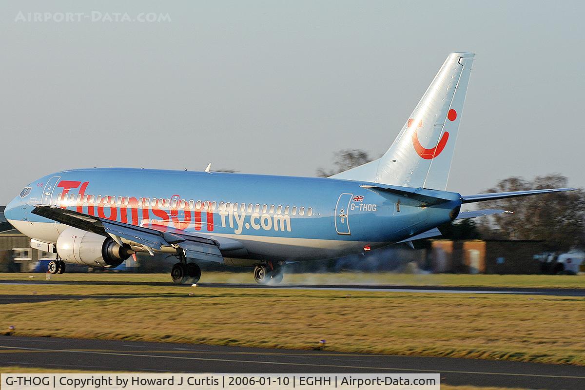 G-THOG, 1997 Boeing 737-31S C/N 29057, Thomsonfly.com, tyres smoking as it touches down.