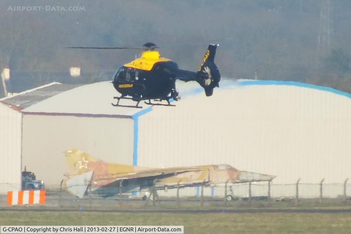 G-CPAO, 2009 Eurocopter EC-135P-2+ C/N 0843, Cheshire Police EC135 taxing to apron november with Mig-27 in the background