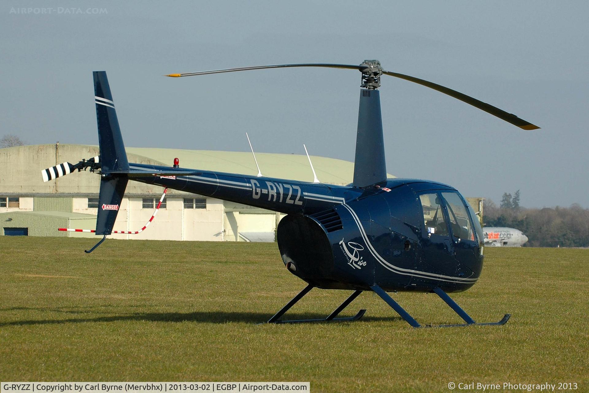 G-RYZZ, 2006 Robinson R44 Raven II C/N 11418, Sitting nicely in the sun.