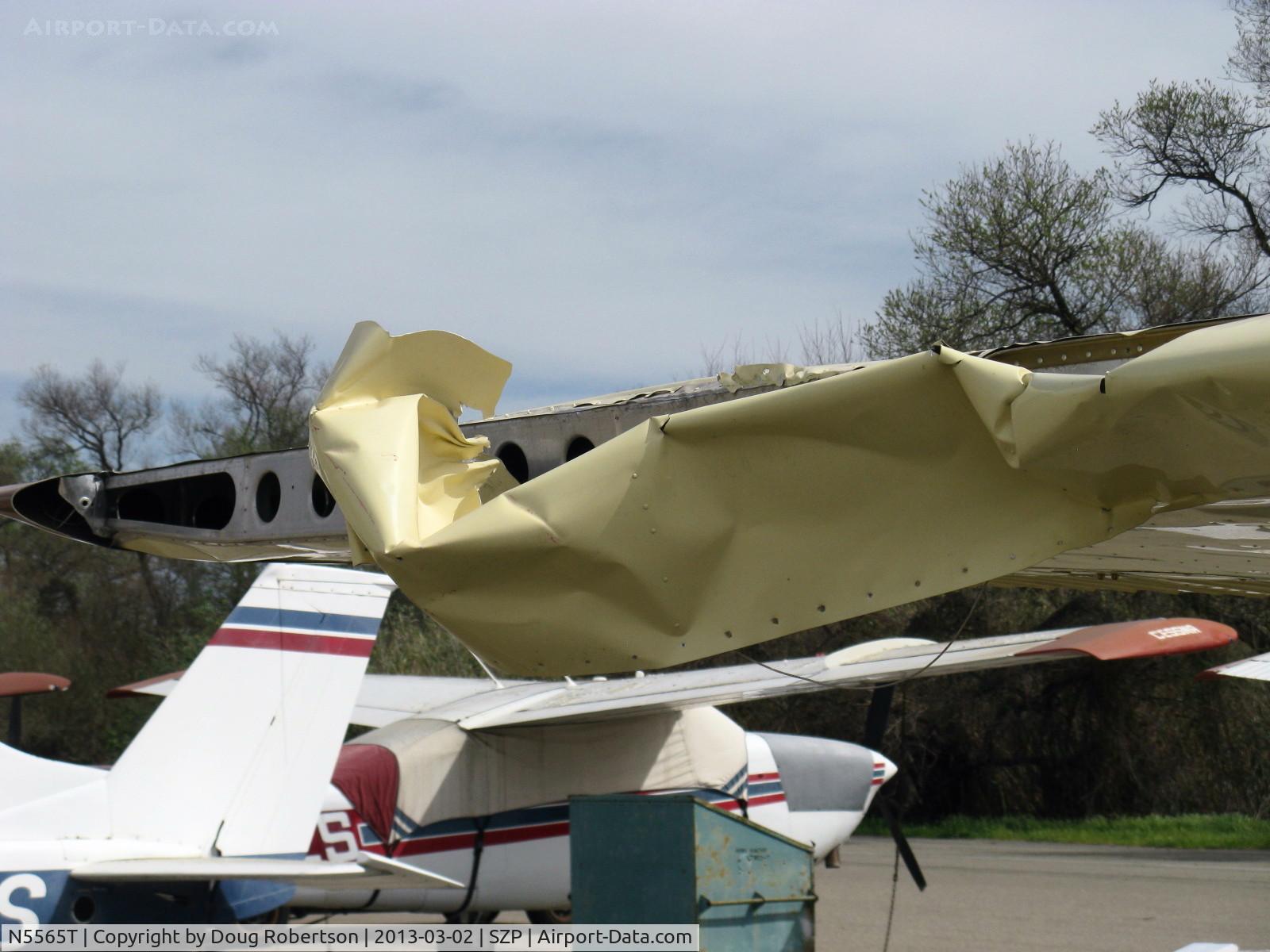 N5565T, 1964 Cessna 172E C/N 17251465, 1964 Cessna 172E SKYHAWK, wing crumpled in landing departure of a red N17445 1931 Waco QCF biplane from Rwy 22. Unlucky tiedown parking spot. Adjacent Bonanza had a wing destroyed by an earlier Rwy 22 departure.