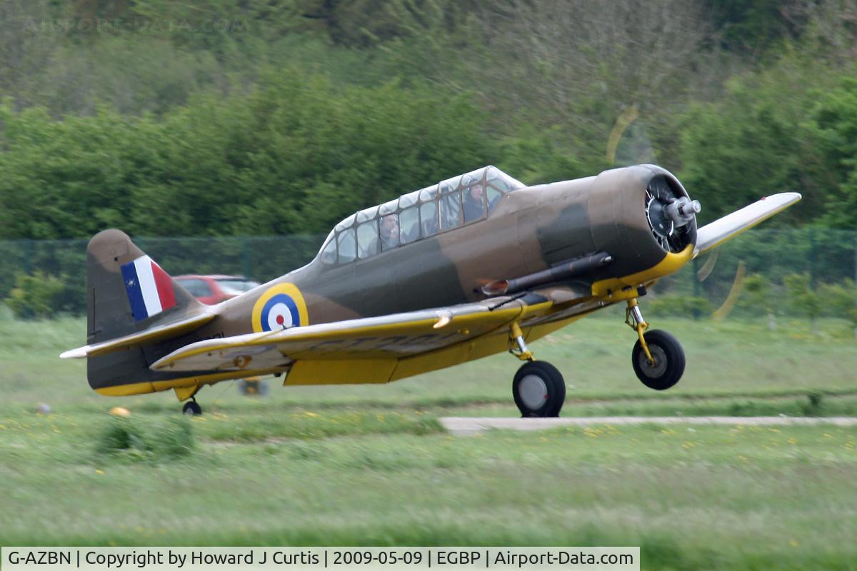 G-AZBN, 1942 Noorduyn AT-16 Harvard IIB C/N 14A-1431, At the Great Vintage Flying Weekend. Privately owned, painted as FT391. Caught by a gust of wind as it landed, the starboard wing grounded on the runway; no lasting damage was done.