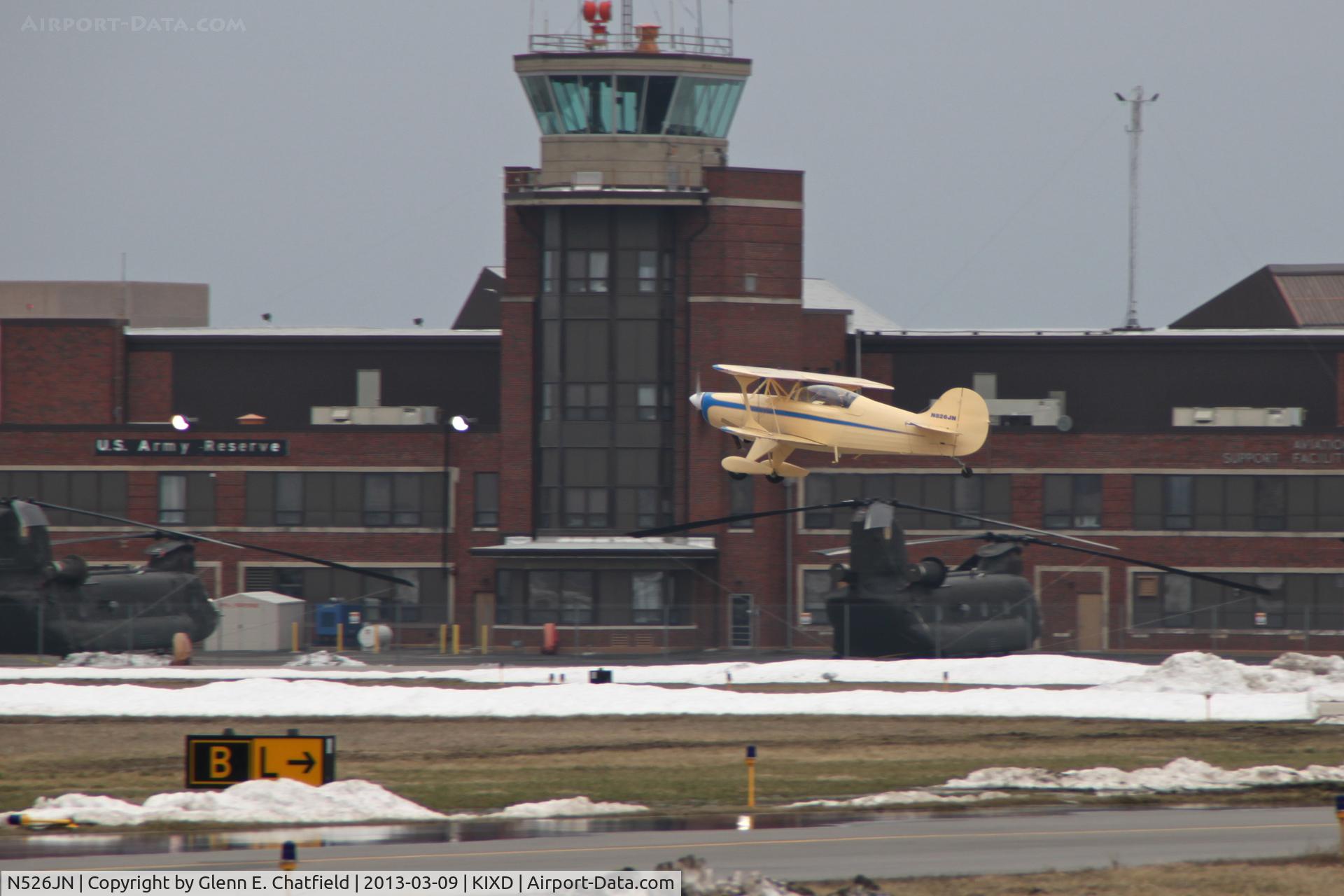 N526JN, Steen Skybolt C/N 001 (N526JN), Climbing out, with the Army Reserve unit in the background.