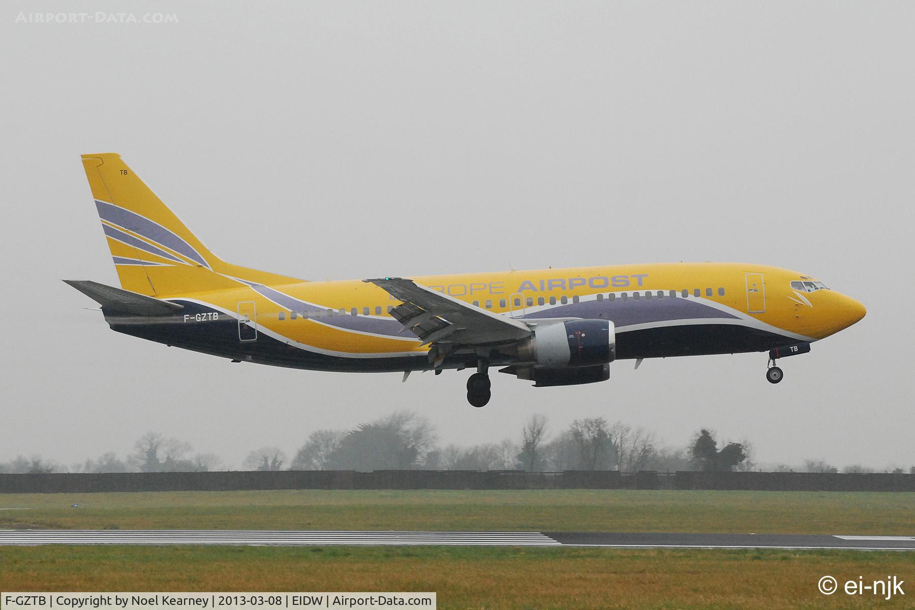 F-GZTB, 1999 Boeing 737-33V C/N 29336, Landing Rwy 10 at Dublin in the rain..