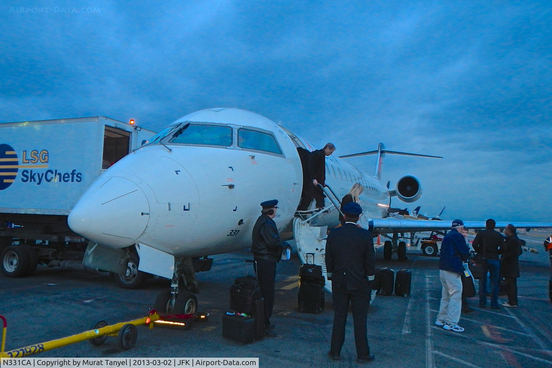 N331CA, 2002 Bombardier CRJ-701ER (CL-600-2C10) Regional Jet C/N 10061, Disembarking at JFK