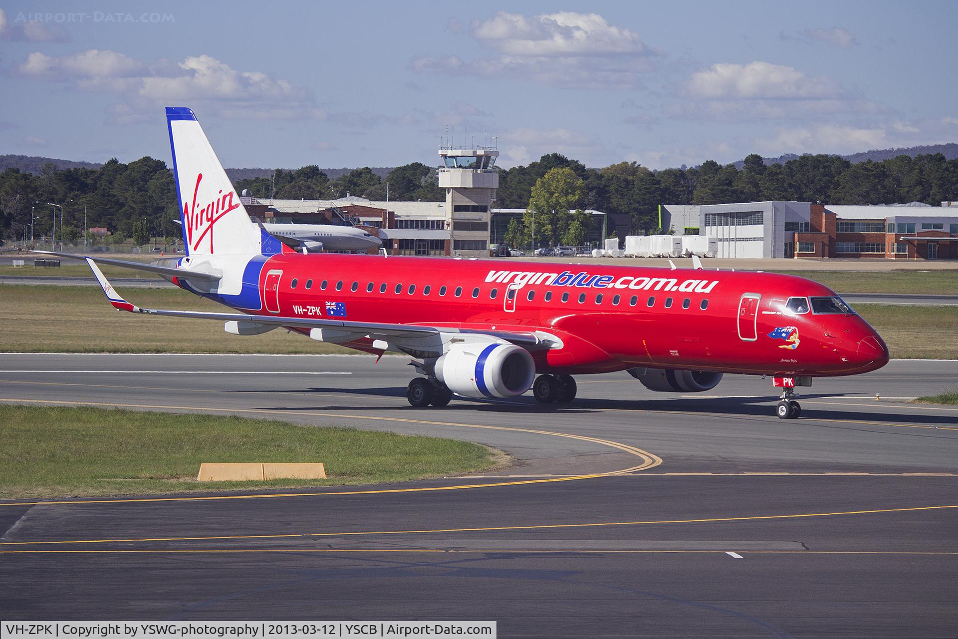 VH-ZPK, 2008 Embraer 190AR (ERJ-190-100IGW) C/N 19000218, Virgin Australia, still in the former Virgin Blue livery, (VH-ZPF) Embraer ERJ-190AR taxiing to the terminal at Canberra Airport.