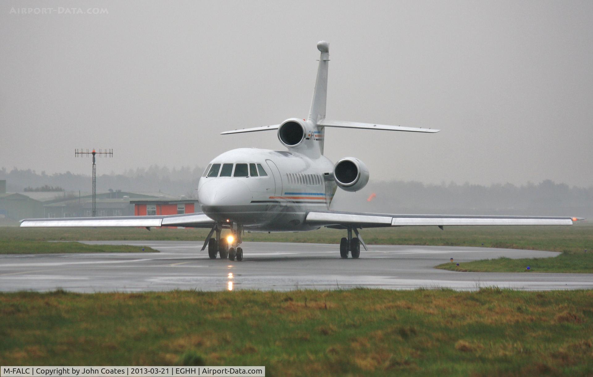 M-FALC, 1998 Dassault Falcon 900EX C/N 31, Taxiing to depart in pouring rain