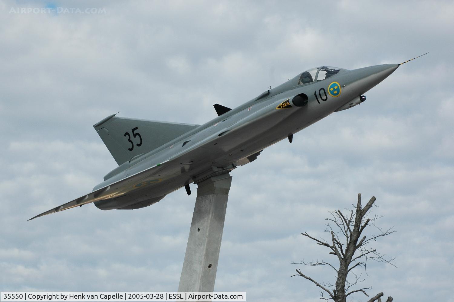35550, Saab J-35F Draken C/N 35-550, Saab J35F fighter mounted on a pole at the parking area of the Saab plant at Linköping in Sweden.