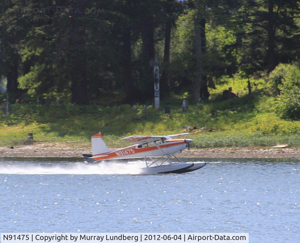 N91475, 1969 Cessna 180H Skywagon C/N 18052097, Taking off in front of an old cemetery at Hoonah, Alaska.