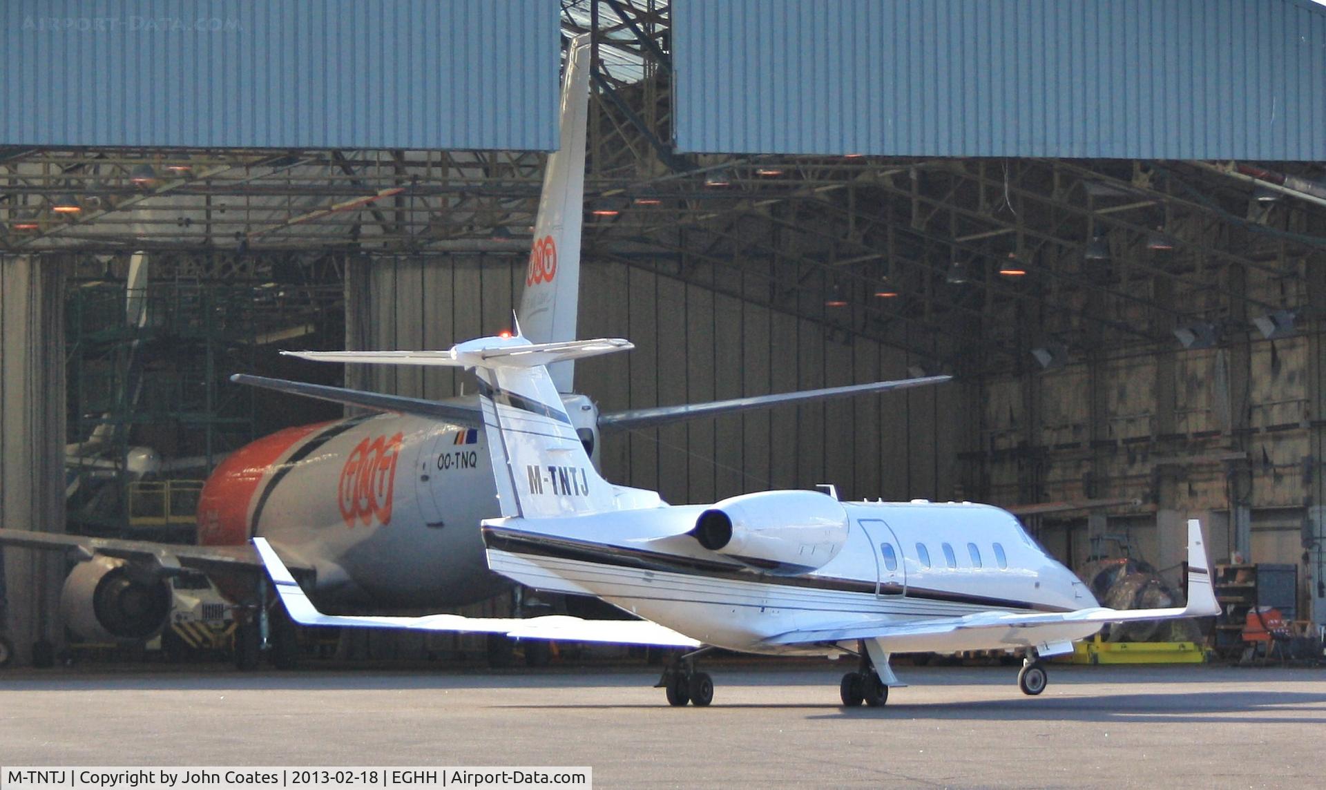 M-TNTJ, 1983 Learjet 55 C/N 55-087, Crew arriving for OO-TNQ, still in service bay